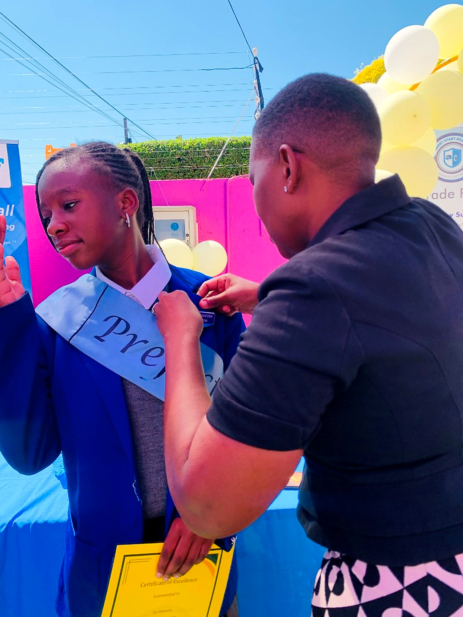 A prefect receiving her sash and certificate